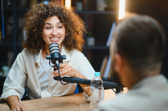 Two content creators recording podcast in home studio