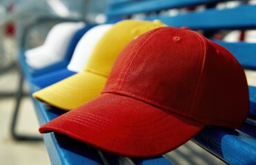 Line of baseball caps in various colors