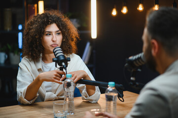 Two content creators recording podcast in professional studio