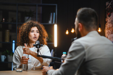 Two content creators recording podcast in modern studio