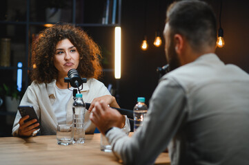 Content creators recording podcast in modern studio