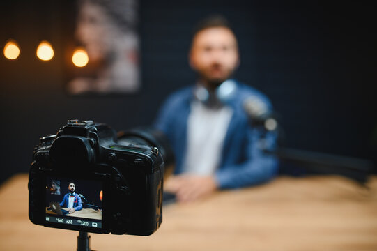 Video blogger recording content with professional camera in studio