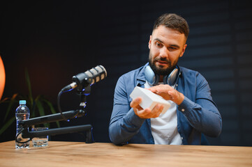 Video blogger recording product review in home studio