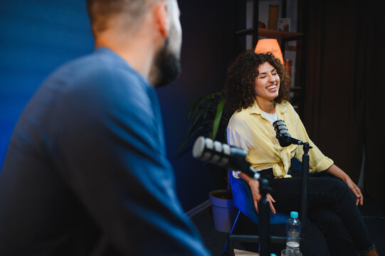 Two content creators recording podcast in home studio