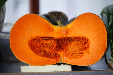 Fresh pumpkin cut in half showing seeds and fibrous texture