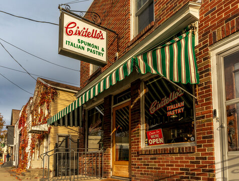 Schenectady, NY - US - Nov 15, 2025 Civitello&rsquo;s Spumoni and Italian Pastry glows in warm afternoon light, its striped awning, brick fa&ccedil;ade, and vintage signage creating a classic neighborhood charm.