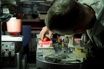 Close-up of a worker interacting with a machine in a production environment
