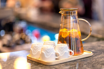 Summer refreshing homemade chilled drink with mint and citrus and ice. Nonalcoholic iced tea, lemonade with lemon. Chilled water with herbs