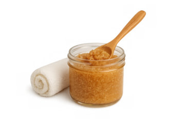 Body scrub in a clear jar, featuring a wooden spoon and rolled white towel. Concept for spa, exfoliation, skincare, and natural beauty