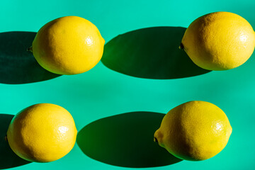 A vibrant yellow lemon resting on a table, captured in soft natural light. The image highlights the fruit&rsquo;s bright color, fresh texture, and simple composition, making it suitable for food photography