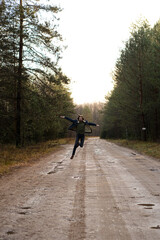 Man Dancing and Having Fun on Dirt Road Through Forest
