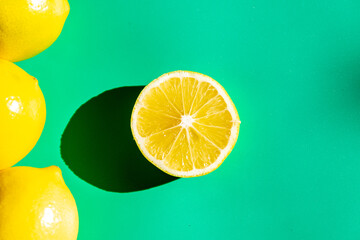A vibrant yellow lemon resting on a table, captured in soft natural light. The image highlights the fruit&rsquo;s bright color, fresh texture, and simple composition, making it suitable for food photography