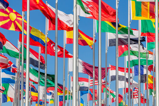 National flags of many countries waving in the wind, including Brazil, Spain, Saudi Arabia, Iraq, Oman, Sri Lanka, Macedonia, Ethiopia and Egypt, Doha, Qatar - Powered by Adobe