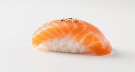 Close-up of nigiri sushi; salmon atop rice with sesame seeds, on a white surface