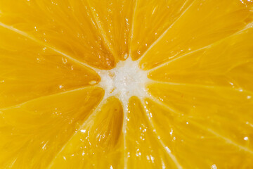 A vibrant yellow lemon resting on a table, captured in soft natural light. The image highlights the fruit&rsquo;s bright color, fresh texture, and simple composition, making it suitable for food photography