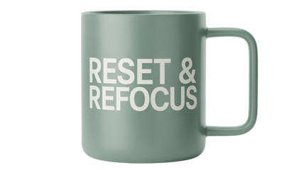 A stylish green mug with RESET & REFOCUS message.