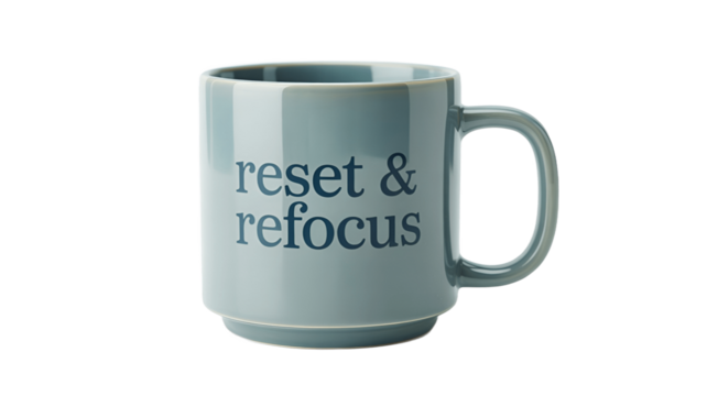 A ceramic mug with the words reset & refocus printed on its surface.