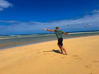 Man Running on the Beach with Arms Wide Open