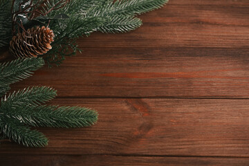 Festive pine branches with holiday decor on rustic wooden table perfect for seasonal celebrations