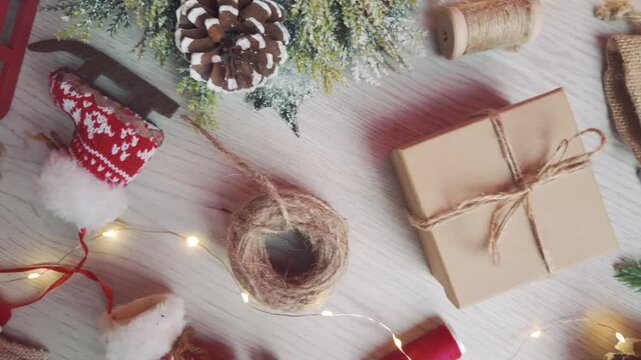 Top-view camera moves right over Christmas decorations, presenting a warm handcrafted holiday tabletop layout