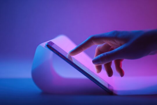 Mobile Phone Scrolling: Woman's Hand Using Page App in Neon Light