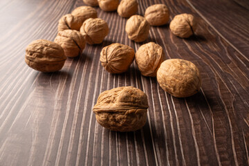 Walnuts, walnuts in their shells, and accessories positioned on a dark rustic table, Selective Focus.
