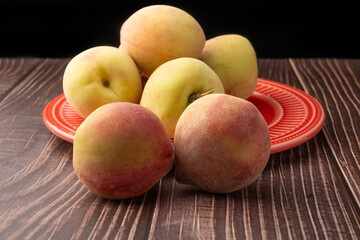 Peaches, beautiful peaches in a porcelain dish positioned on a rustic table, Selective Focus.
