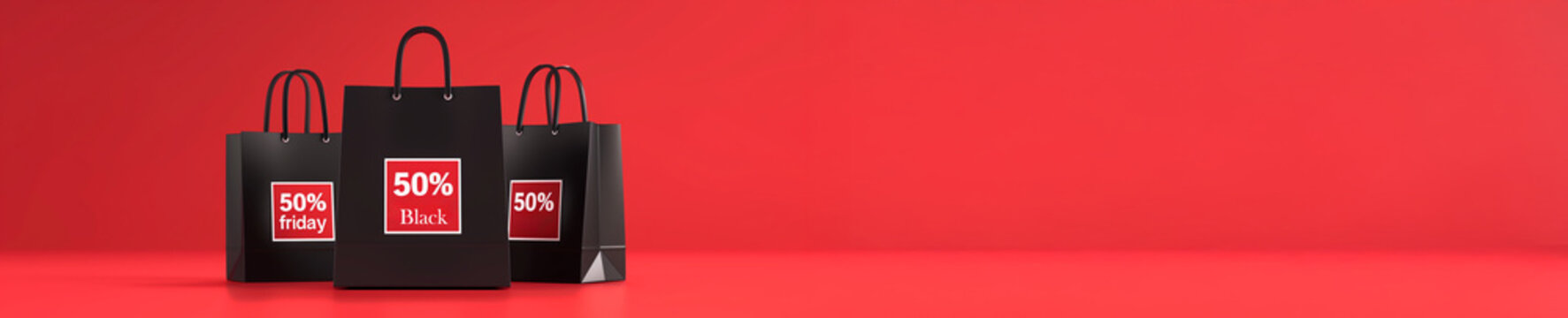 Sacs shopping noirs avec &eacute;tiquettes rouges portant le texte en anglais "50% OFF" sur fond rouge vif avec espace n&eacute;gatif copyspace, visuel commercial pour campagnes de soldes Black Friday fin novembre