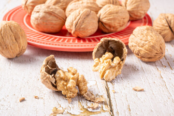 Walnuts, walnuts in their shells, and accessories positioned on a rustic table, Selective Focus.
