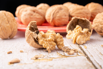 Walnuts, walnuts in their shells, and accessories positioned on a rustic table, Selective Focus.