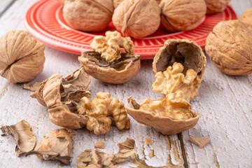 Walnuts, walnuts in their shells, and accessories positioned on a rustic table, Selective Focus.