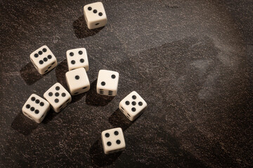 Dice thrown randomly onto a dark surface and dark background, Selective Focus.