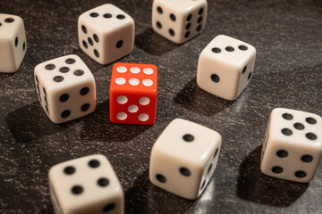 Dice thrown randomly onto a dark surface and dark background, Selective Focus.