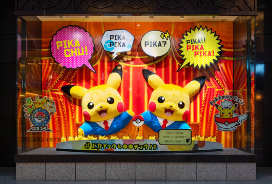 osaka, shinsaibashi - dec 6 2022: Pok&eacute;mon Center Osaka DX show window featuring Pikachu mascots plushies performing Japanese manzai comedy routine with Pok&eacute; Balls and vivid comic-style speech bubbles.