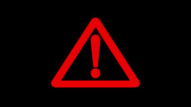 Red warning attention sign animation on black background.