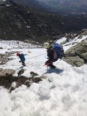 Man with his son making progress through snowy terrain
