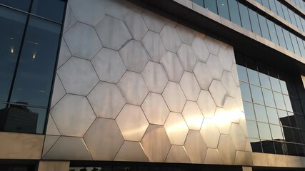 Modern steel building with geometric design featuring a prominent clock on its exterior wall, showcasing forward thinking innovation, precision, and punctuality, perfect for backgrounds or.