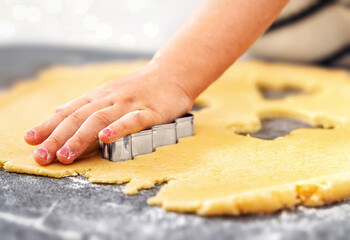 Child hand cooking Christmas cookies holiday baking