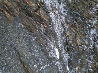 Rugged Rock Face With White Veins And Granular Texture In Mountain Cliff BC, Canada Scene