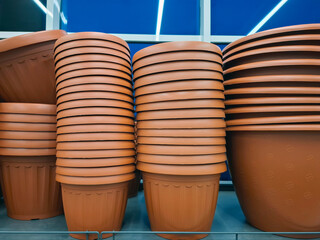 Naklejka premium Plastic large flower pots are sold at a flower shop