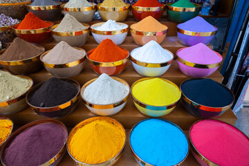 Traditional spices market. Pots and wooden tubs stand in row with colorful tea, spices, fruits, roots, flowers. Street bazaar. Dubai, UAE. Top view