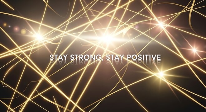 Abstract golden light streaks against a dark background create a sense of energy and movement, with the motivational message stay strong, stay positive - Powered by Adobe