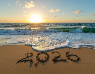 2026 written in sand on a beach at sunset.