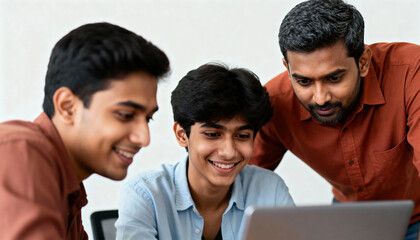 Three young Indian men collaborating on a laptop in an office. A mentor or teacher guides smiling students working on a project. Teamwork and education concept