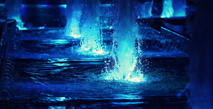 water splashes in a fountain in the dark - Powered by Adobe