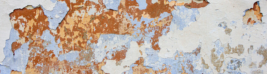 Old paint, plaster texture, peeling layers of paint close-up, concrete wall in need of repair