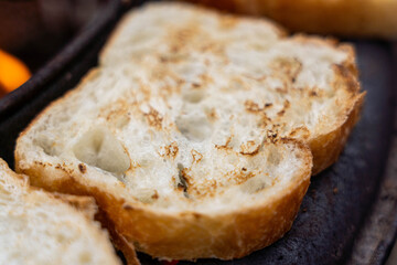 Close-up of toasted bread slices on a grill, showcasing golden-brown crust and soft interior, perfect for breakfast or culinary presentations with copy space
