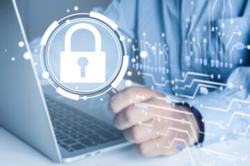 Businessman using laptop to analyze cybersecurity. IT specialist inspecting data protection and network security with virtual padlock icon and circuit board.
