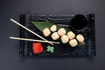 Japanese rolls, fish, black background