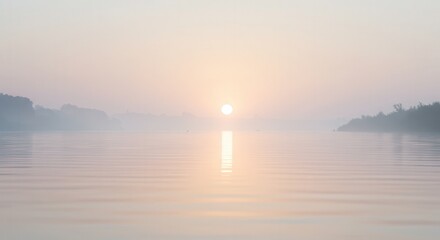 Naklejka premium Calm lake surface reflecting a pale rising sun through gentle morning mist, creating a peaceful minimal background for stage text and contemplative visuals